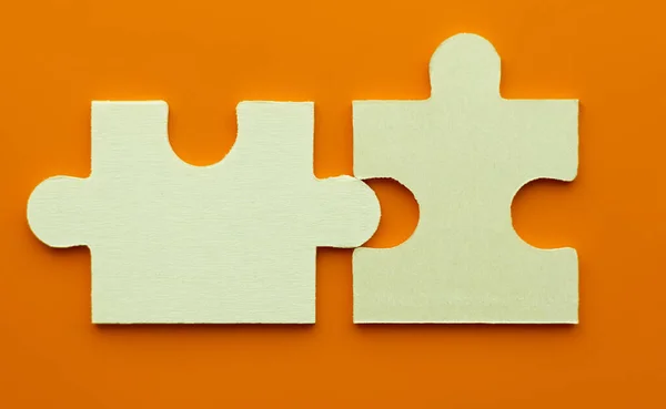 Jigsaw teamwork concept macro shot. Connect couple puzzle piece. Symbol of association and connection, business strategy, completing, team support and help concept.