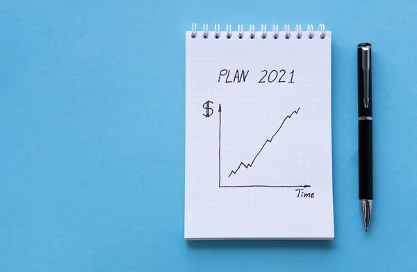 Diretamente acima vista de bloco de notas branco na mesa azul. Caderno com o cronograma de filmagem do topo. Caderno espiral fundo azul. Ver através de contas e finanças domésticas — Fotografia de Stock