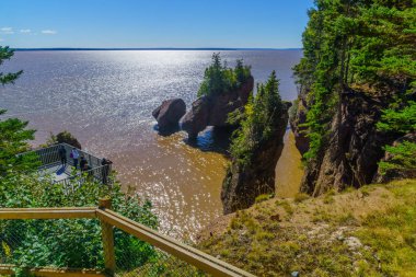 Hopewell Cape, Canada - September 24, 2018: View of Hopewell Rocks at high tide, with visitors. New Brunswick, Canada clipart