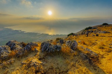 Arbel, İsrail - 14 Ağustos 2020: Galilee Denizi 'nin sabah manzarası, Arbel Dağı' ndan, ziyaretçilerle birlikte. Kuzey İsrail