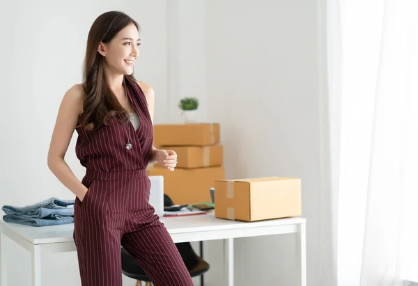 Young Asian casual woman working small business owner standing l