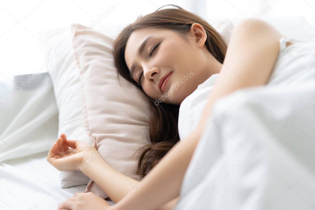 Closeup portrait of a calm young pretty Asian woman sleeping in 