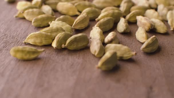 Cardamom seeds on the wooden table — Stock Video