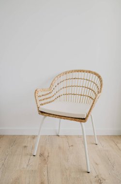 İçi boş beyaz duvar arka planında koltukla dolu. İskandinav tarzı detaylar. Hafif, şirin ve rahat bir ev. Boşluğu kopyala.