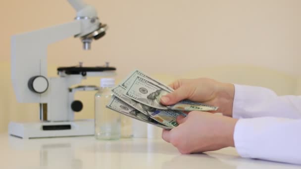 Doctor Counts Money Laboratory — Stock Video