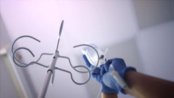 Läkaren på sjukhuset lägger dropparen på disken — Stockvideo