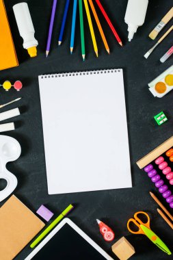 Okul malzemelerinin olduğu boş bir eskiz defteri. Okul konseptine geri dönelim. Çerçeve, düz döşeme, metin için kopyalama alanı. maket yap