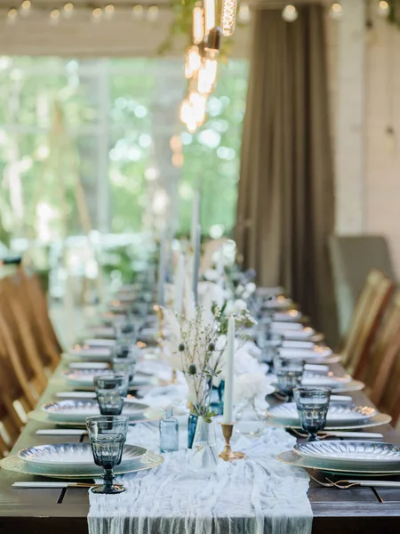 blue and gold boho wedding decor. festive wedding table setting. Selective focus. Grainy effect