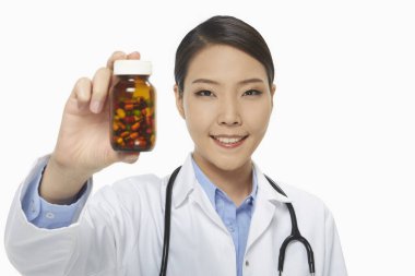 Cheerful medical personnel holding up a bottle of pills clipart