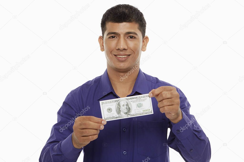 Businessman holding a single cash note