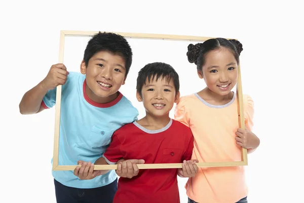 Dzieci Trzymające Drewnianą Ramę Uśmiechnięte — Zdjęcie stockowe