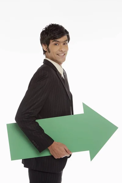 Biznesmen Trzymający Zieloną Strzałę Lewo — Zdjęcie stockowe