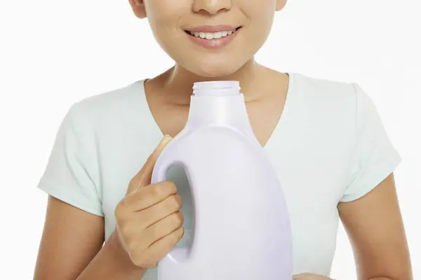 Woman Smelling Bottle Detergent — Stock Photo, Image