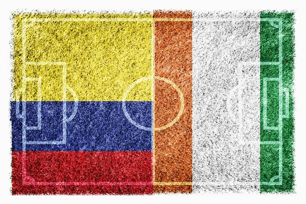 Flags of Colombia and Ivory Coast on soccer field