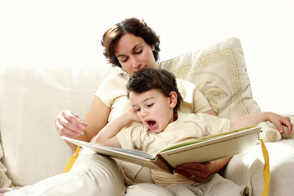 Woman Sitting Couch Reading Story Book Her Young Son — Stockfoto