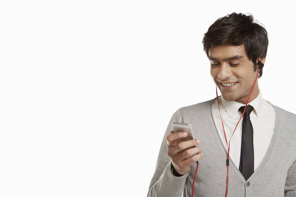 Man smiling and using mobile phone