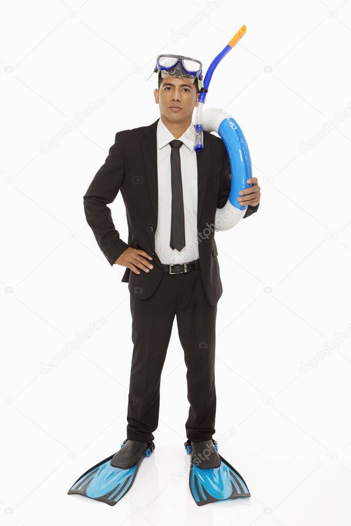 Businessman with swimming gear looking at the camera