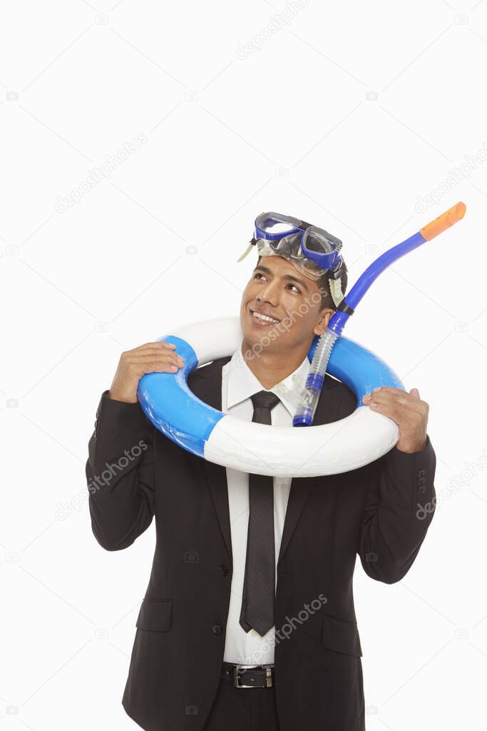 Businessman with swimming gear smiling
