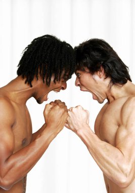 Side shot of an African American man and a man screaming and looking at each other in anger