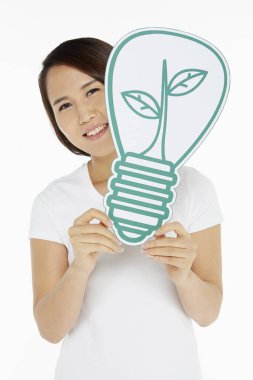 Woman holding up a light bulb made of cardboard clipart