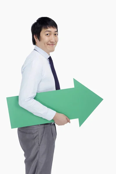 Businessman Holding Arrow Pointing Left — Stock Photo, Image