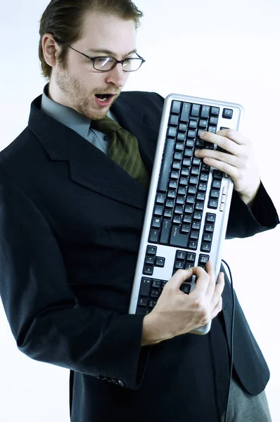 Bespectacled Man Holding Computer Keyboard Playing Guitar — 스톡 사진