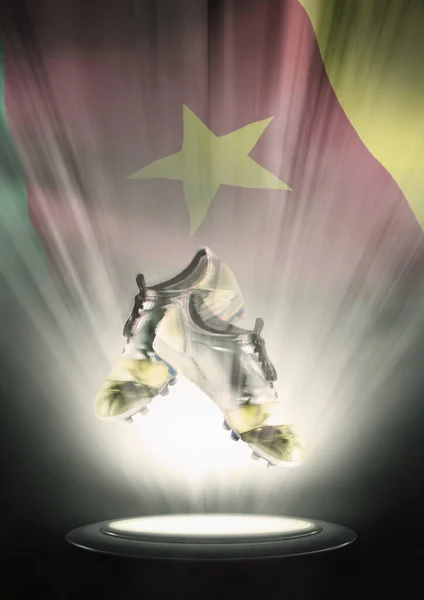 Football cleats with Cameroon flag backdrop
