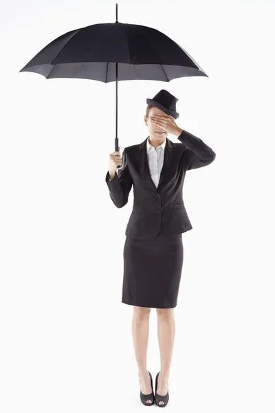 Businesswoman Covering Her Eyes While Standing Umbrella — Stock Photo, Image