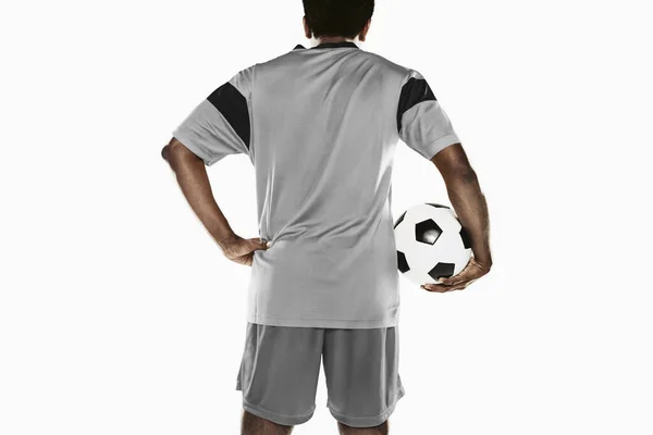 A soccer player holding a ball