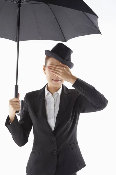 Businesswoman Covering Her Eyes While Standing Umbrella — Stock Photo, Image