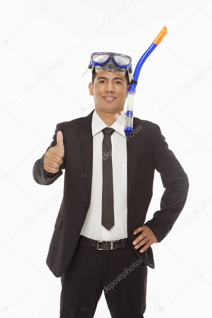 Businessman with swimming gear giving thumbs up