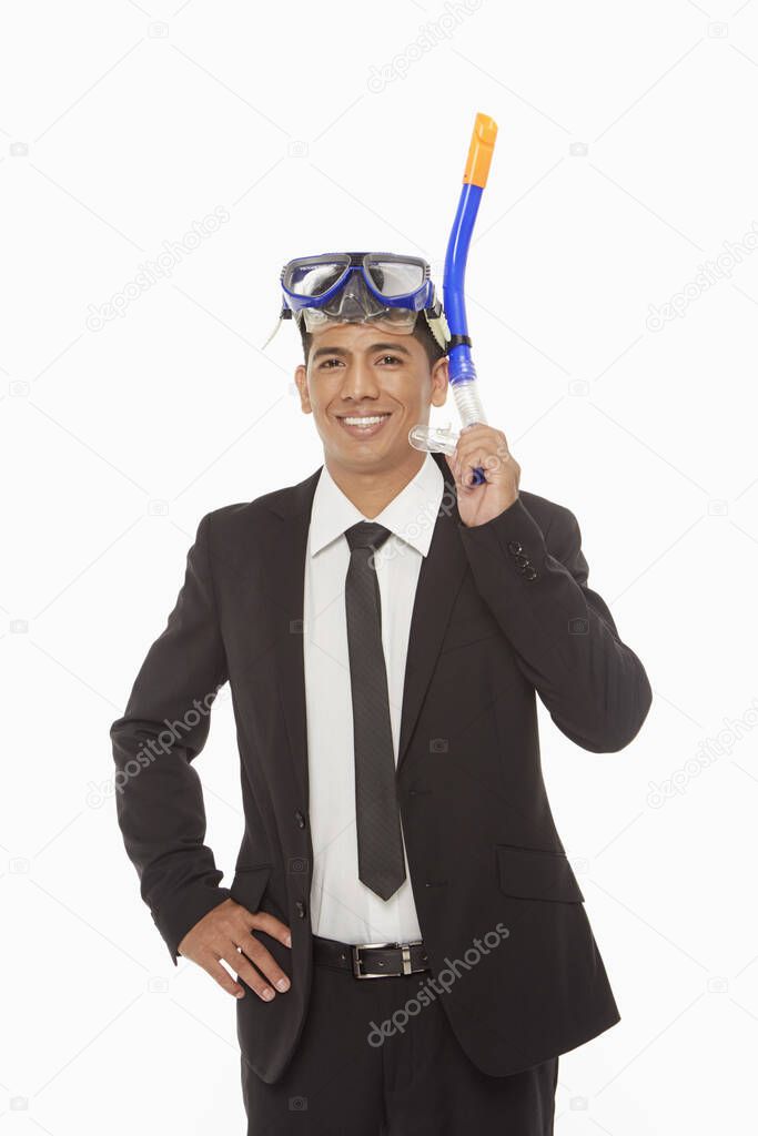 Businessman with swimming gear smiling at the camera