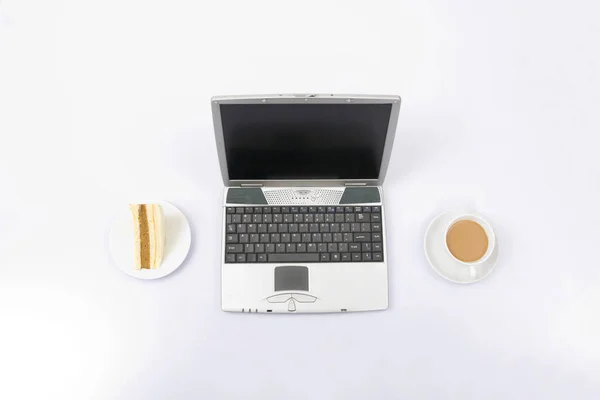 Laptop with coffee and sandwich