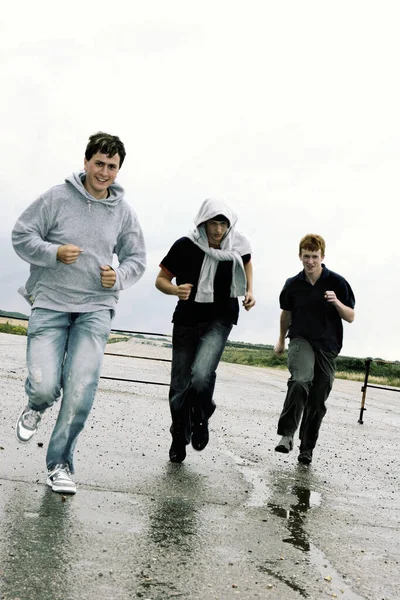 Three Boys Running Street — Stockfoto