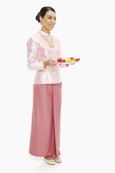 身穿传统服装的妇女举着装有泰国花环的托盘 — 图库照片