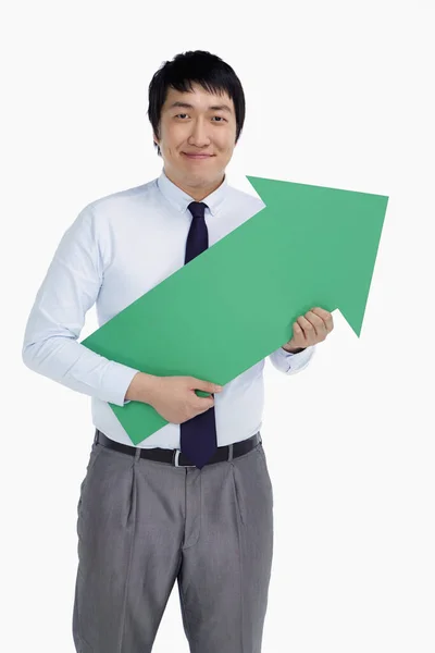 Businessman Holding Arrow Pointing Left — Stock Photo, Image