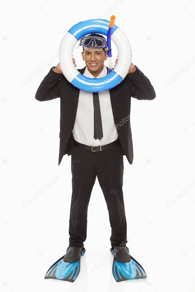 Businessman with swimming gear looking through a swimming tube