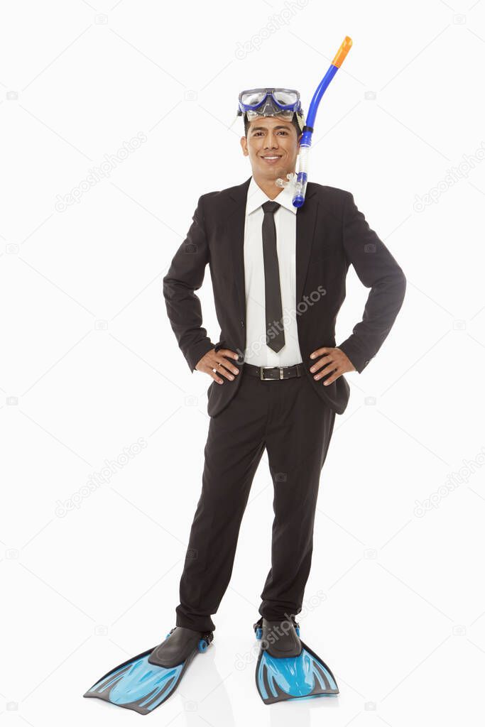Businessman with swimming gear smiling at the camera