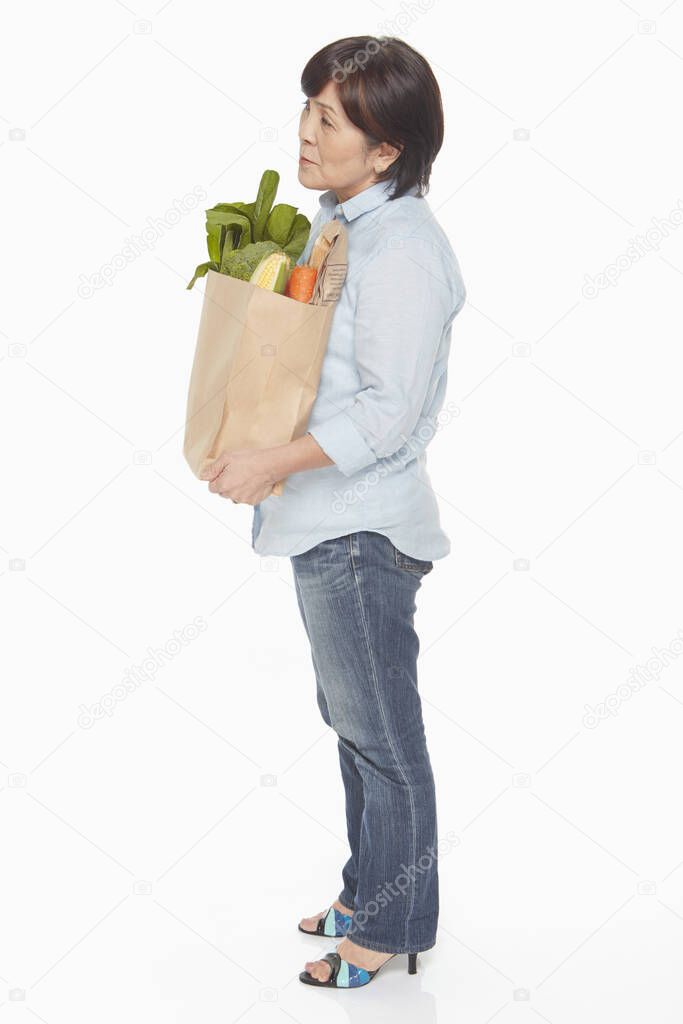 Woman carrying a bag of groceries