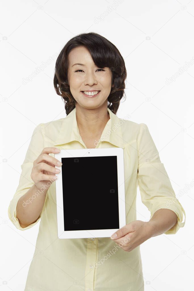 Woman holding up a digital tablet