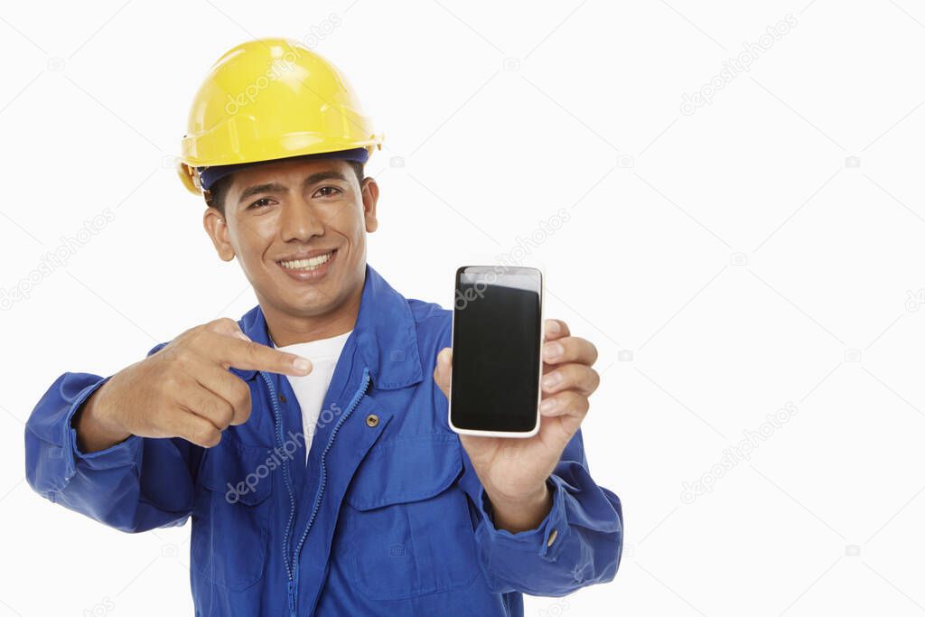 Construction worker holding up a mobile phone