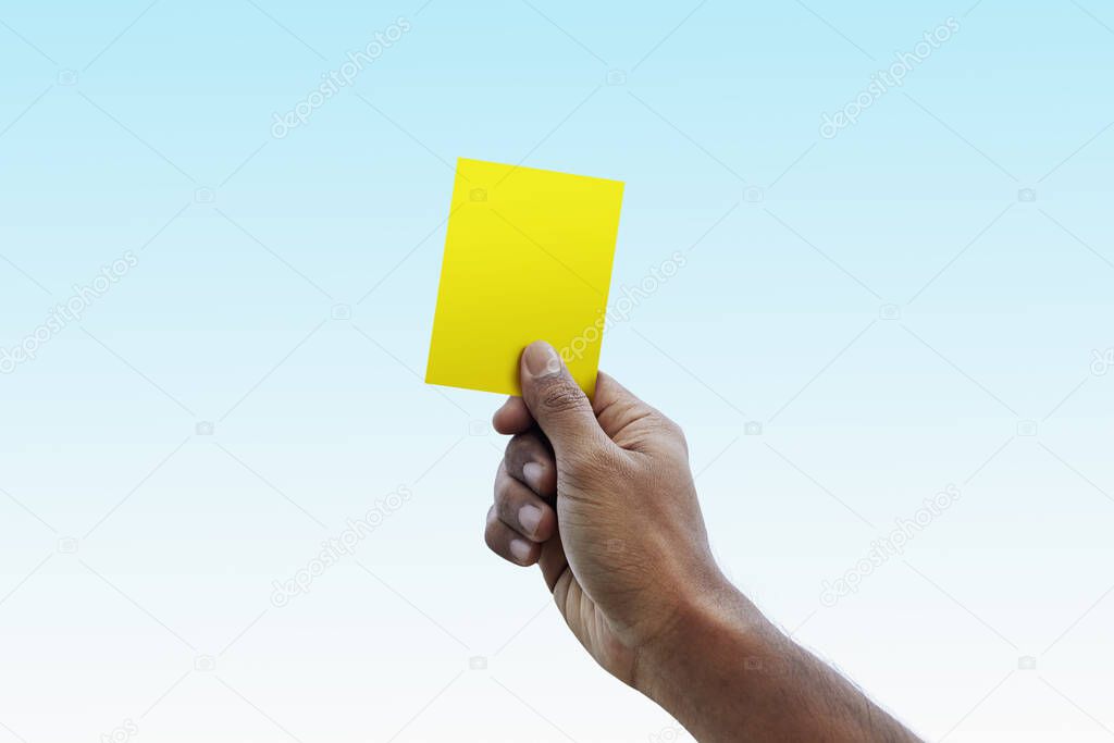 Soccer referee giving yellow card