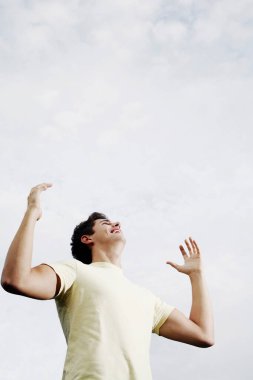 Adam yukarı bakarken gülümsüyor.