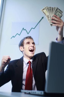 İşadamı banknotlara bakarken gülüyor