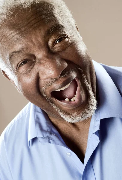 Senior man laughing, close up