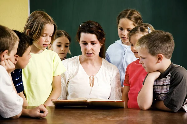 Female teacher reading for her students