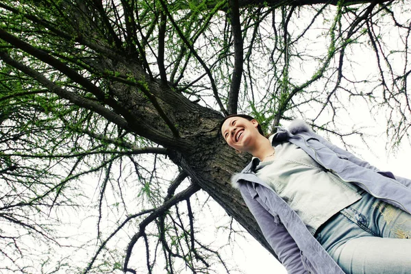 stock image Woman standing under a tree