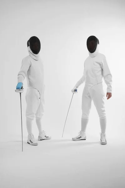 Two Men Fencing Suits Looking Camera — Φωτογραφία Αρχείου