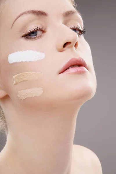 Woman with three shades of foundation on cheek