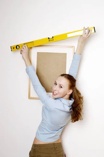 Woman using spirit level